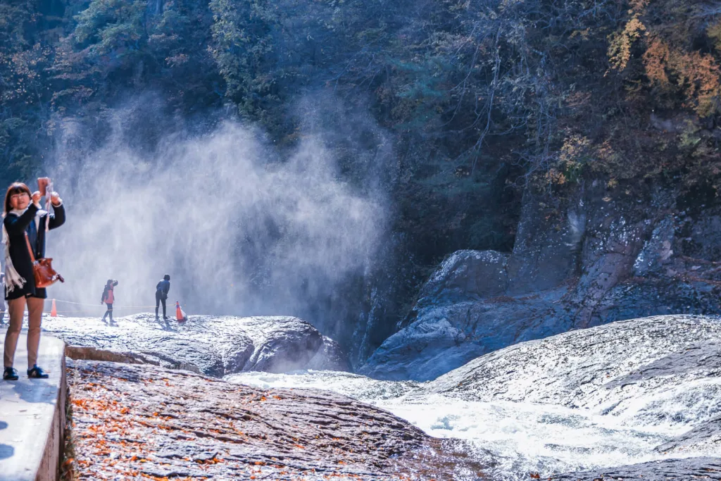 Fukiware Falls in Nikko with white mist rising from the cascading waters in the background.