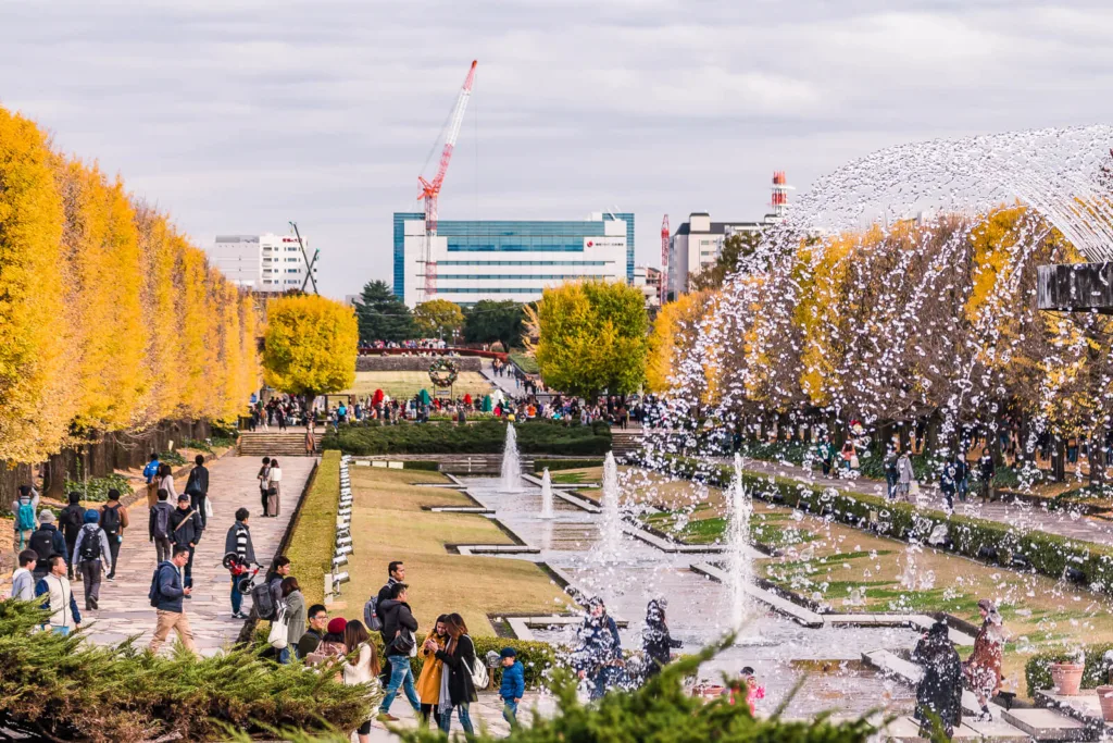 Autumn yellow foliage with a water fountain in the foreground at the Showa Kinen Park