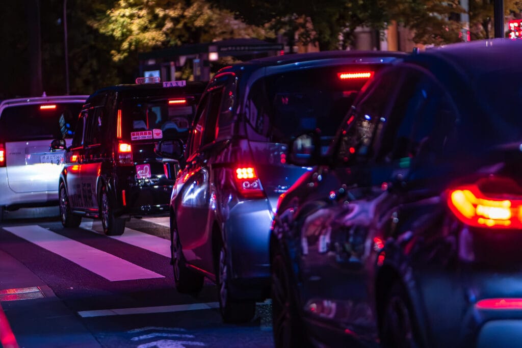 A night view of cars on a Harajuku street
