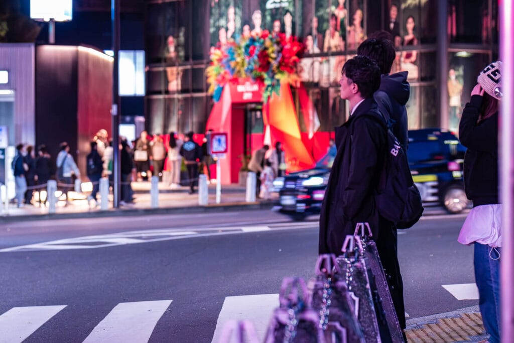 People ready to cross the street at a red light crossing at Harajuku.