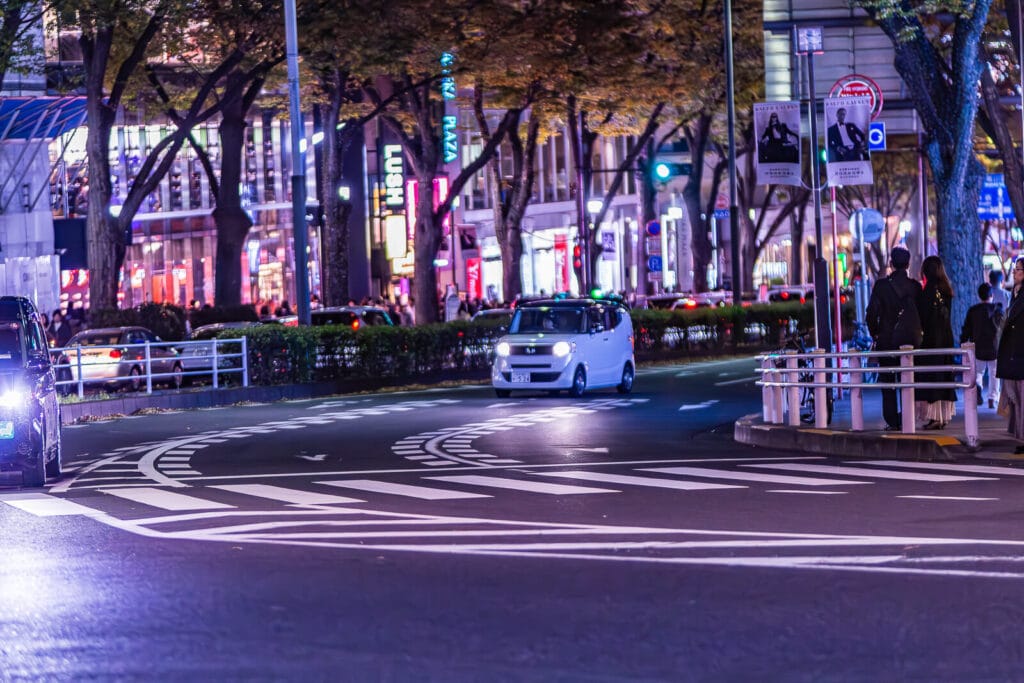 Four wheelers on Omotesando street in the night.
