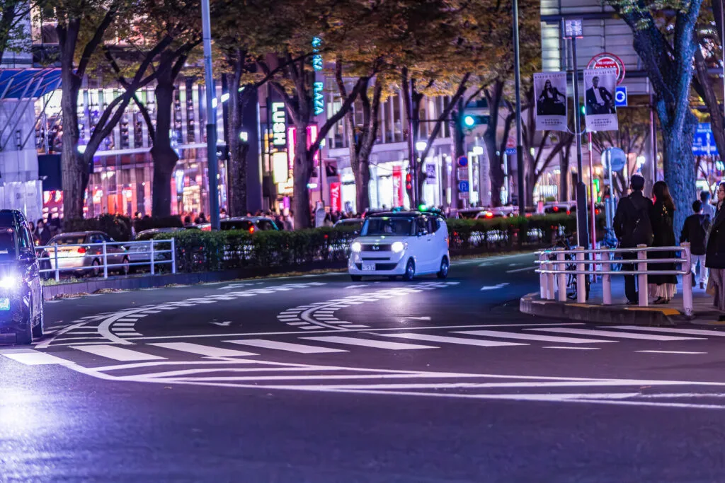 Four wheelers on Omotesando street in the night.