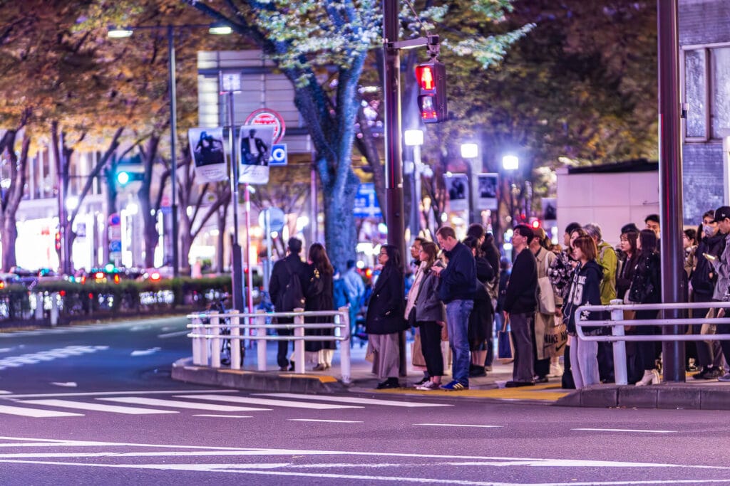 People ready to cross the street at a red light crossing at Harajuku.