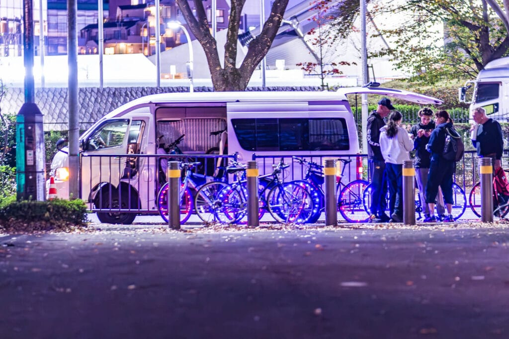 Cyclists conversing on the sidewalks at Harajuku near Yoyogi Park.