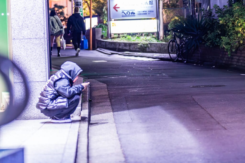 Sitting on the sidewalk at Harajuku