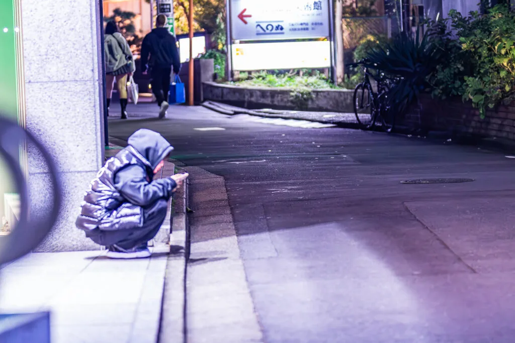 Sitting on the sidewalk at Harajuku