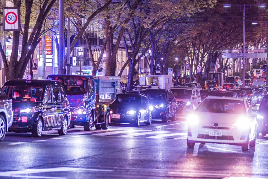 Cars on Omotesando street at night.