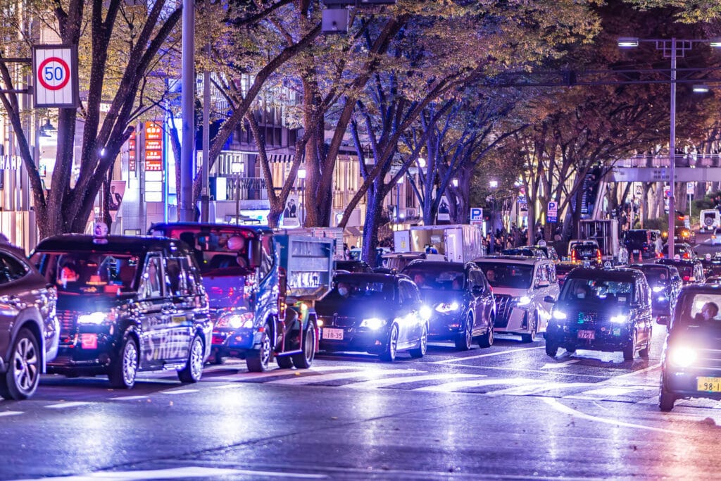 Cars on Omotesando street at night.