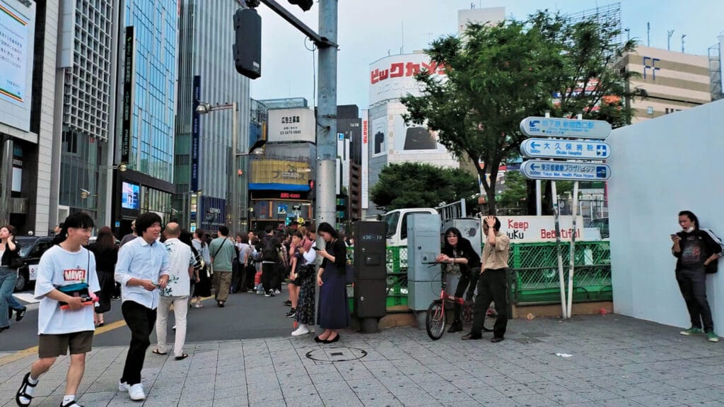 People near Lumine Est Shinjuku in the evening.